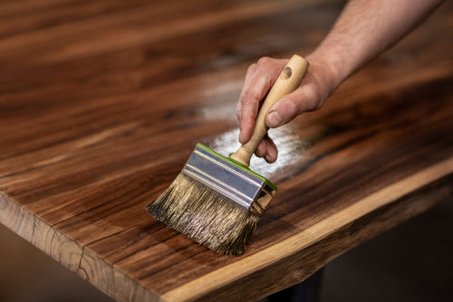 image of person painting their wood countertop with a gloss finish