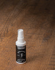 Small spray bottle of wood glue on a wooden surface