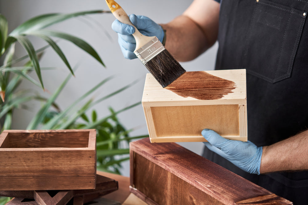 a woodworker applying finishes for ash wood