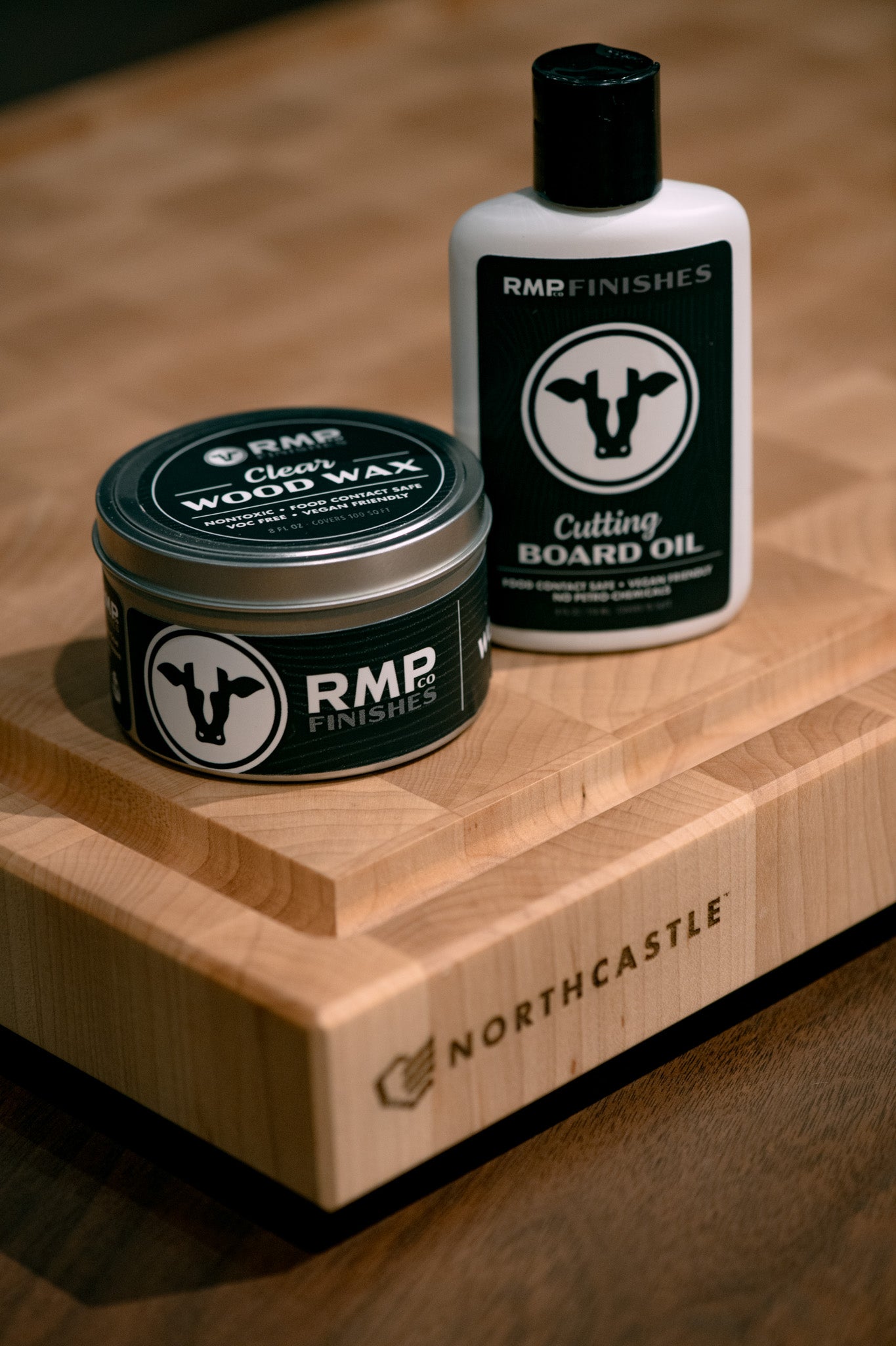 Two RMP Finishes products on a wooden cutting board with 'Northcastle' branding.