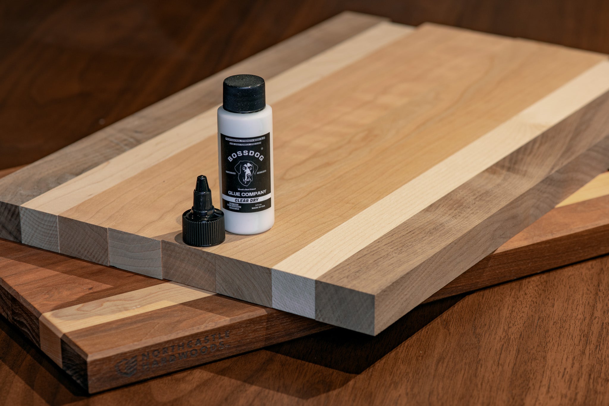 Wooden cutting board with a bottle of wood glue on top