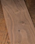 Close-up of a wooden board with visible grain on a textured surface