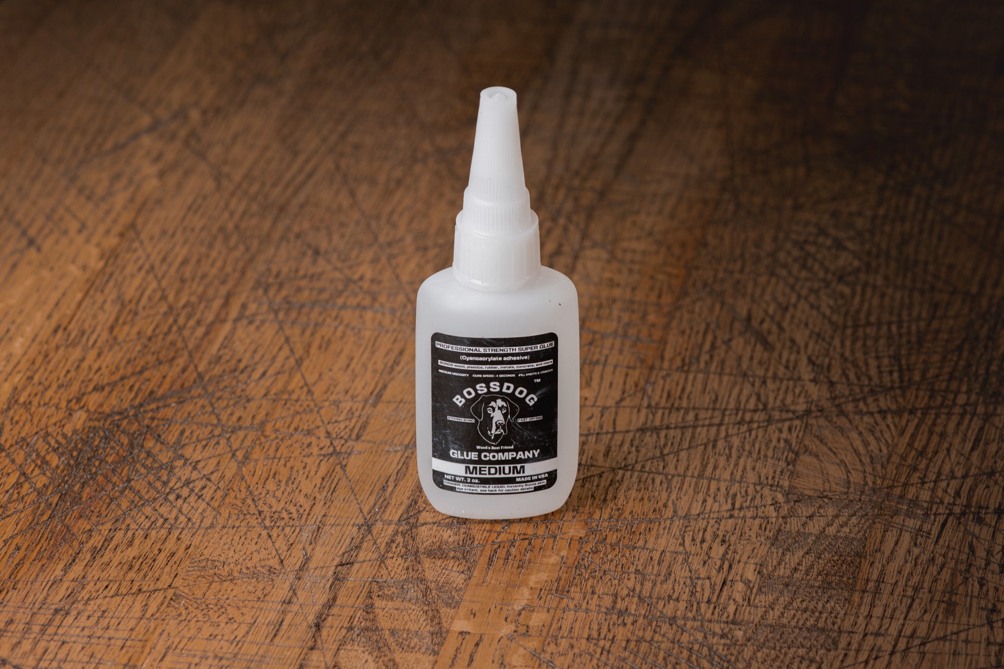 Bottle of BOSSDOG on a wooden surface