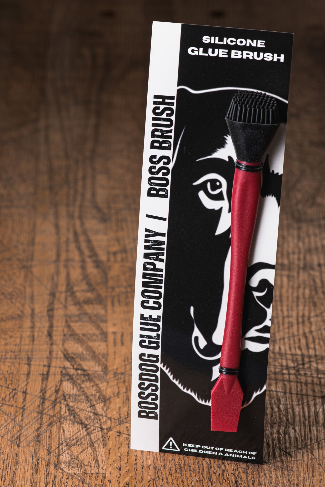 Boss Dog Glue Company silicone glue brush packaging on a wooden surface