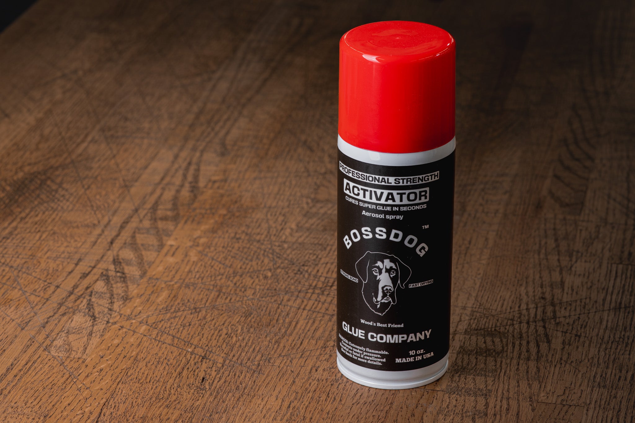 Bossdog activator can on a wooden surface